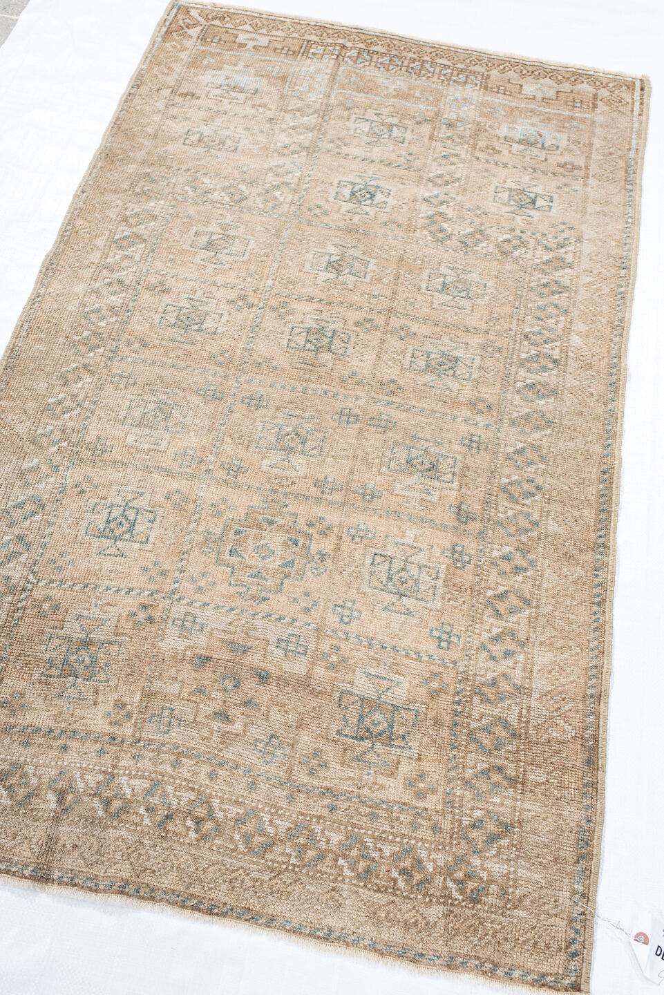 2' x 4' one-of-a-kind handmade vintage Belouch small size rug. Color palette: ivory, taupe, camel, pale blue, brown, sage