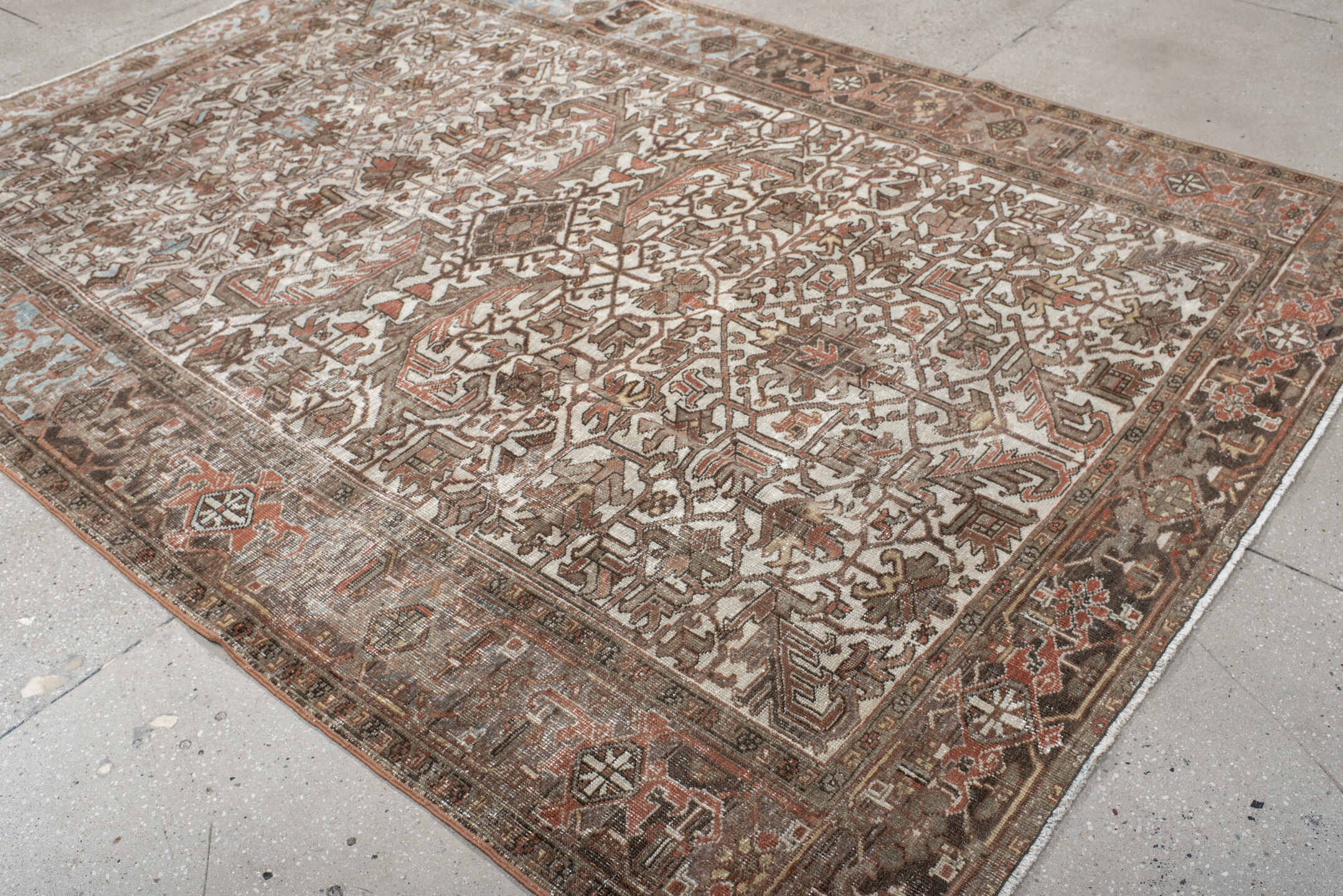 6' x 9' one-of-a-kind handmade antique Heriz medium size rug. Color palette: ivory, brown, sky_blue, rust, taupe, charcoal