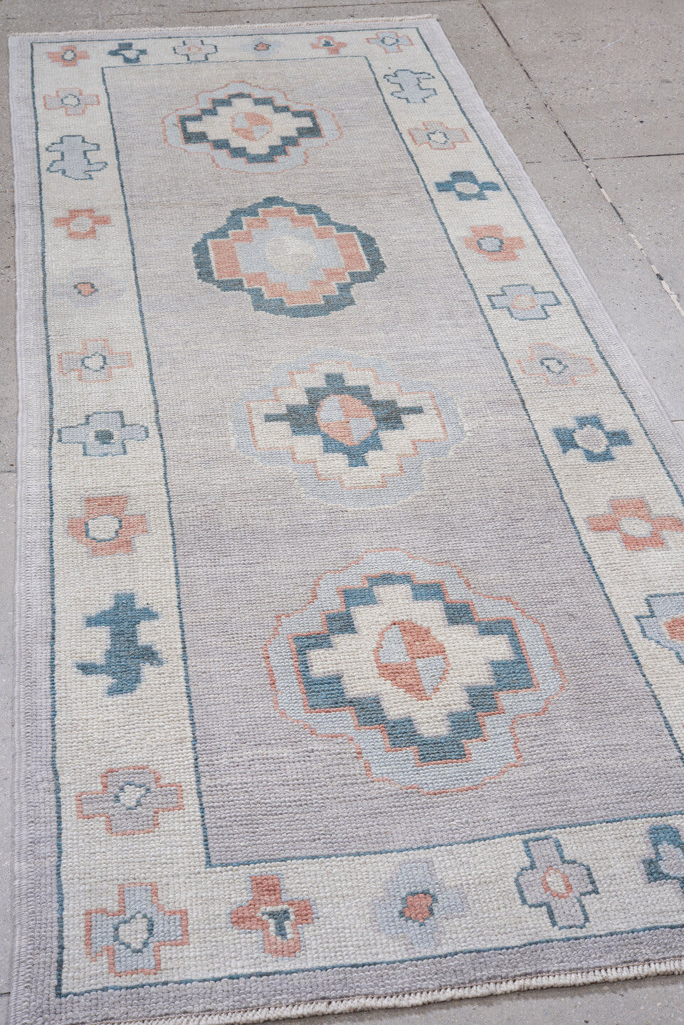 3' x 9' one-of-a-kind handmade vintage Oushak runner rug. Color palette: ivory, pale blue, blush, slate, taupe, light blue