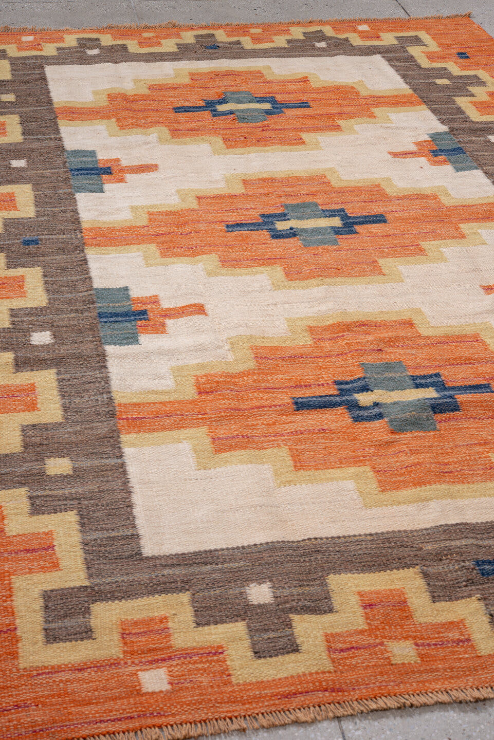 6' x 9' one-of-a-kind handmade antique Rollaken medium size rug. Color palette: orange, ivory, taupe, gold, navy, slate