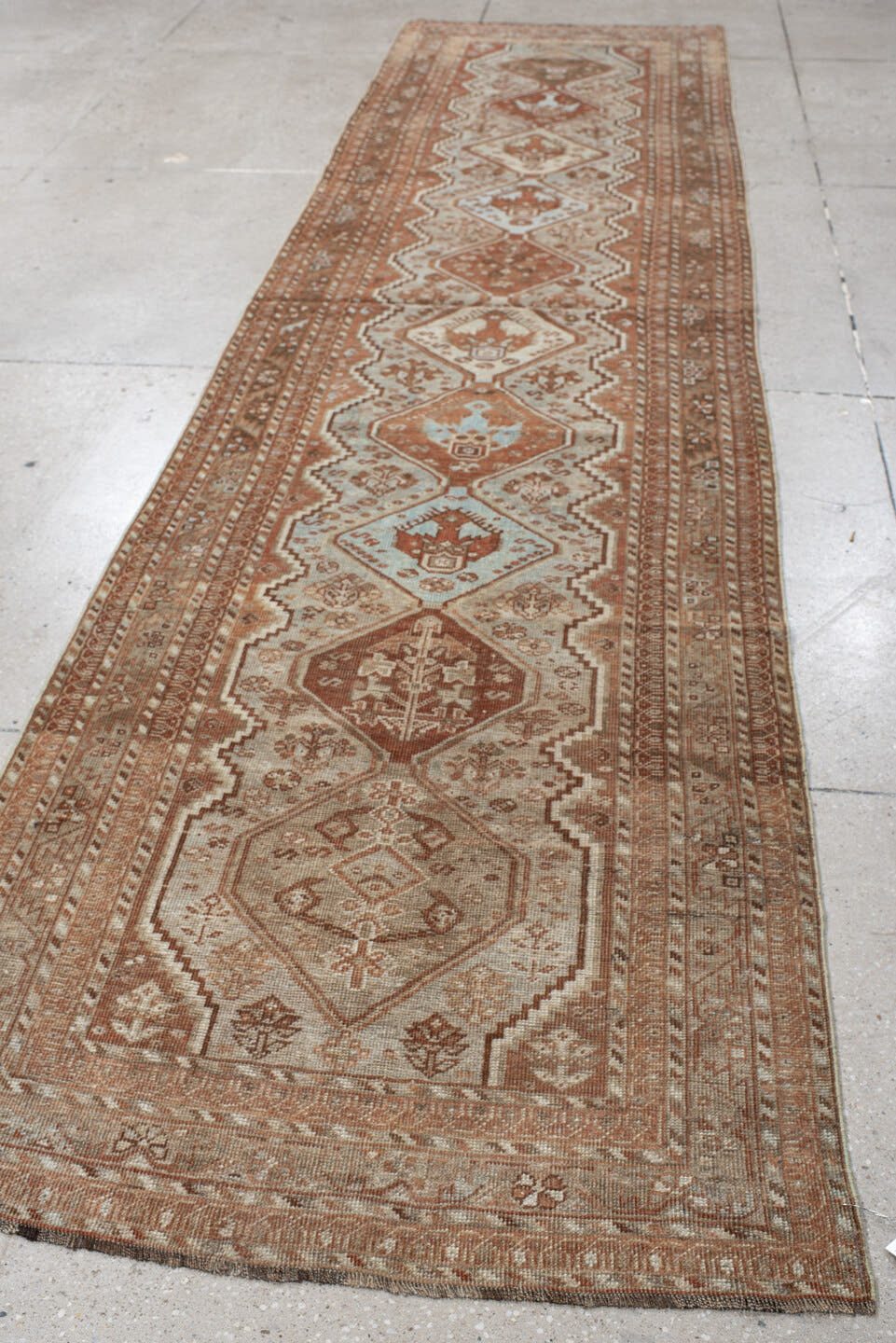 3' x 12' one-of-a-kind handmade vintage Shiraz runner rug. Color palette: ivory, rust, camel, taupe, pale blue, brown