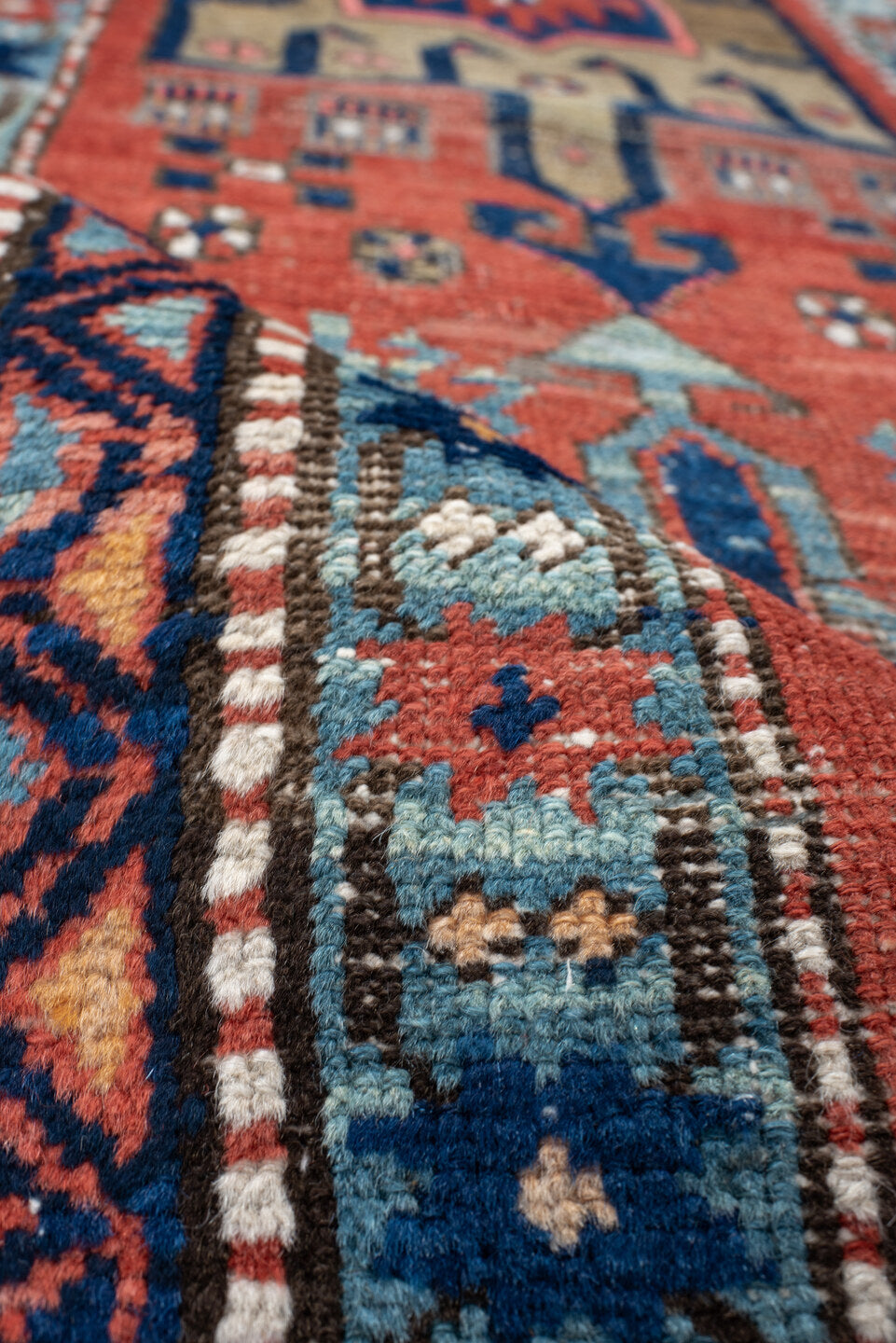 2' x 8' one-of-a-kind handmade vintage Heriz runner rug. Color palette: rust, navy, sky blue, ivory, camel, coral, charcoal