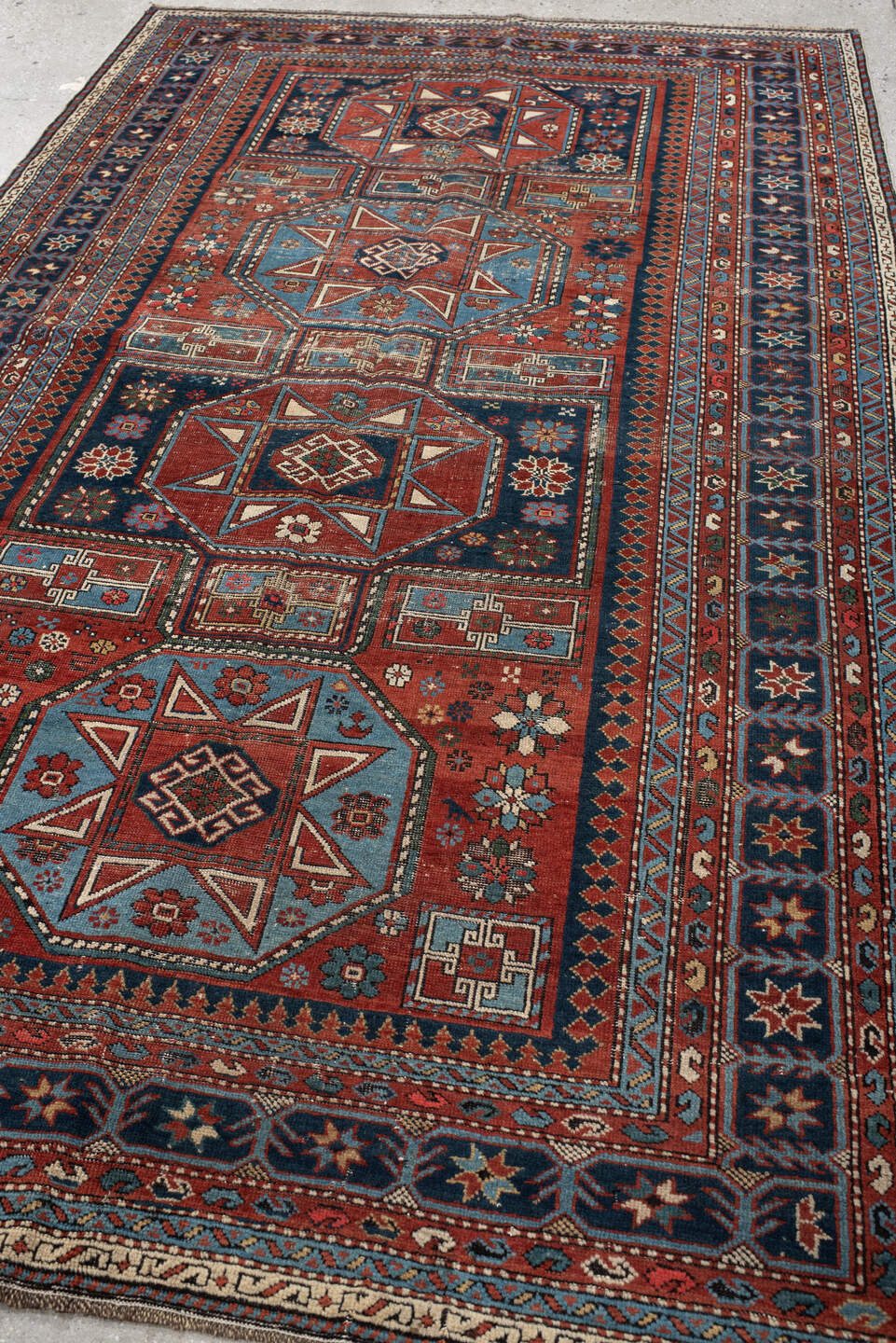4' x 8' one-of-a-kind handmade vintage Shirvan rug. Color palette: rust, navy, sky blue, ivory, terra cotta, slate, cream