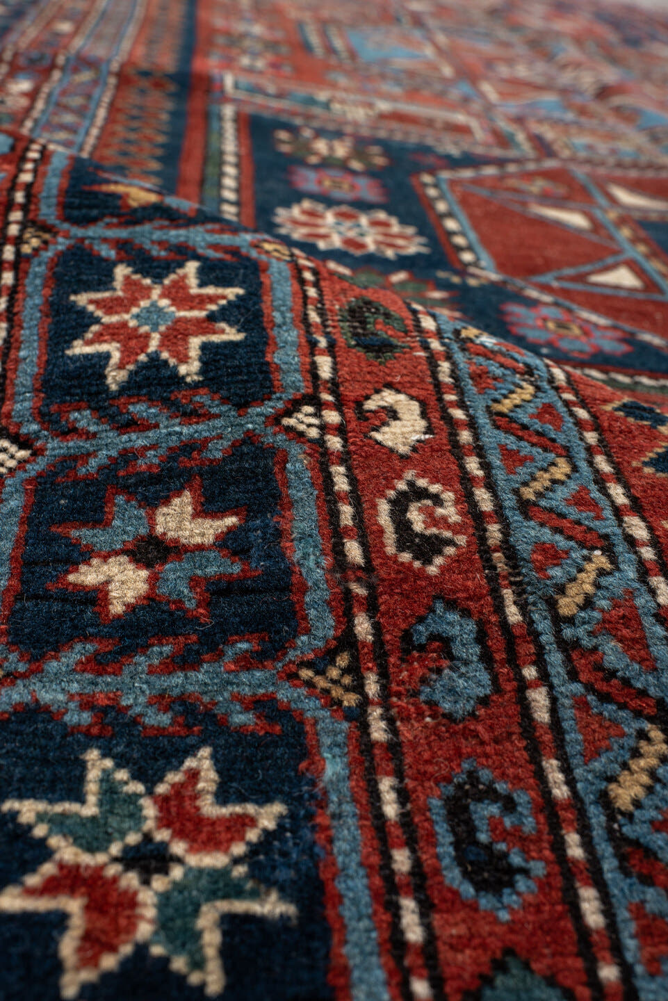 4' x 8' one-of-a-kind handmade vintage Shirvan rug. Color palette: rust, navy, sky blue, ivory, terra cotta, slate, cream