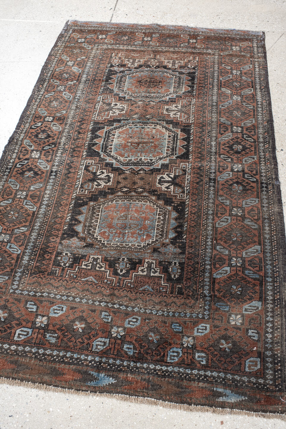 3' x 5' one-of-a-kind handmade antique Belouch small size rug. Color palette: brown, charcoal, rust, sky blue, ivory, taupe
