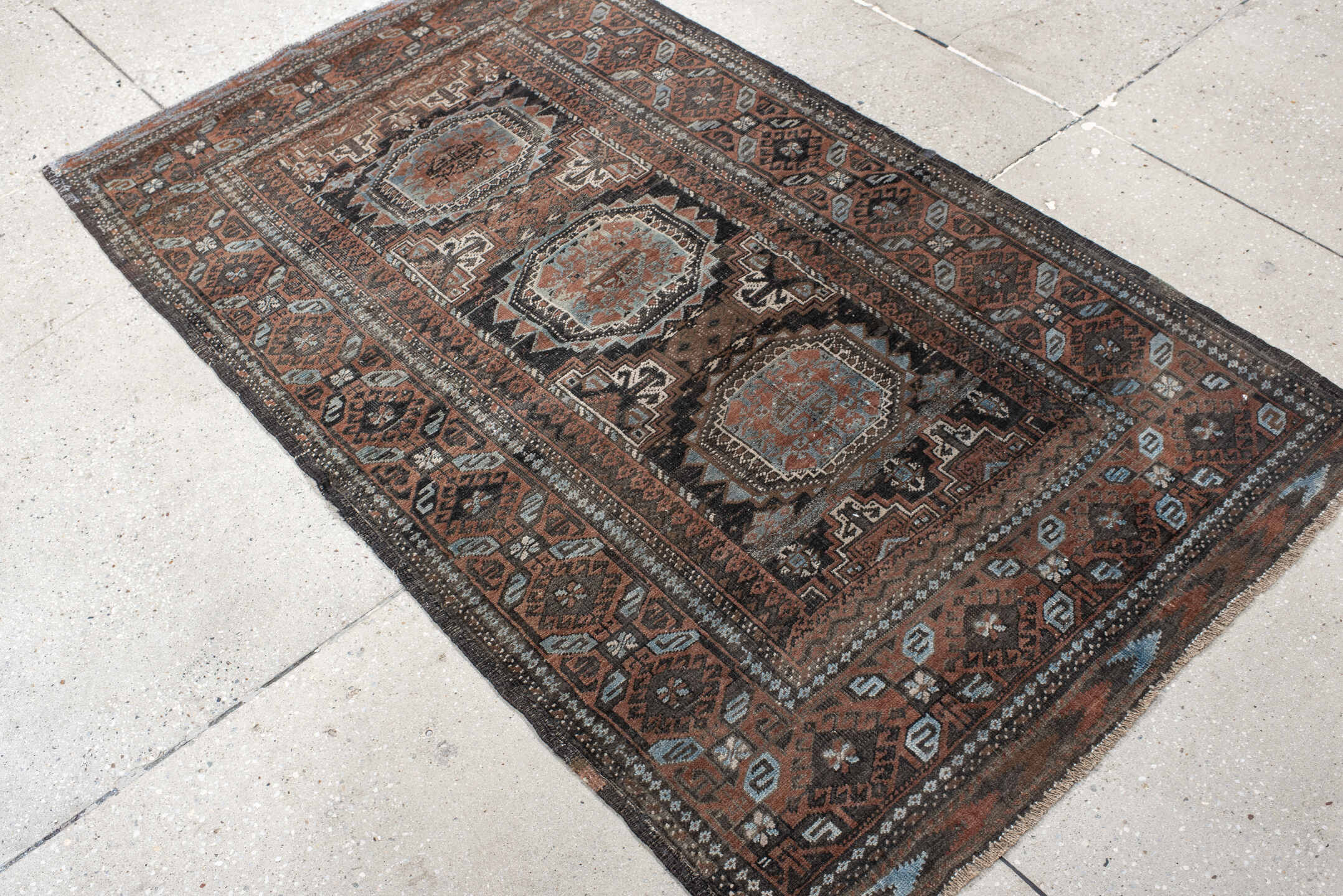3' x 5' one-of-a-kind handmade antique Belouch small size rug. Color palette: brown, charcoal, rust, sky blue, ivory, taupe