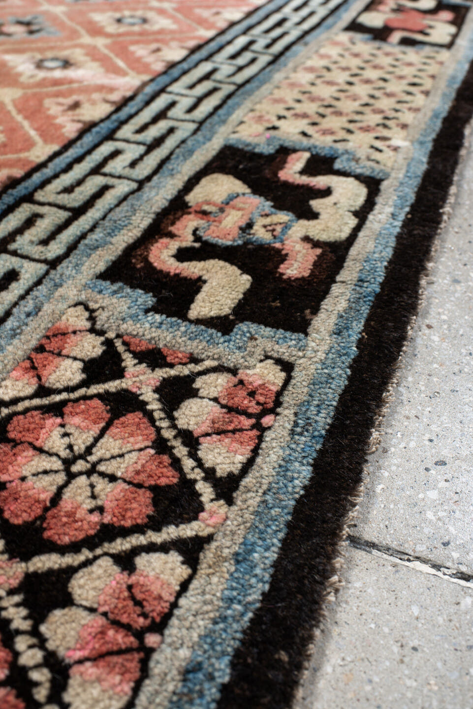 4' x 7' one-of-a-kind handmade vintage Tibetan rug. Color palette: salmon, charcoal, sky blue, ivory, rose, taupe, brown