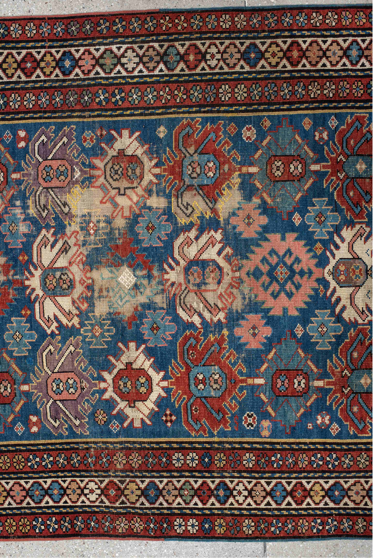 4' x 11' one-of-a-kind handmade vintage Caucasian runner rug. Color palette: arapawa, black, blue, brown, gray