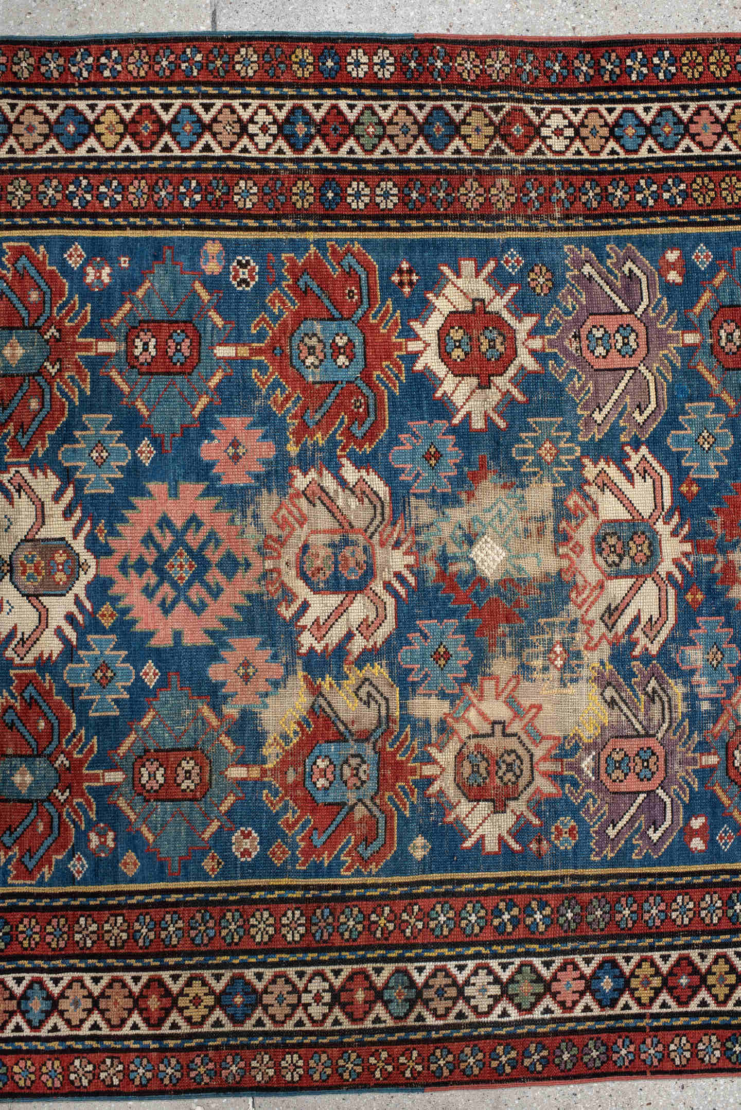 4' x 11' one-of-a-kind handmade vintage Caucasian runner rug. Color palette: blue, rust, ivory, indigo, terra cotta, camel