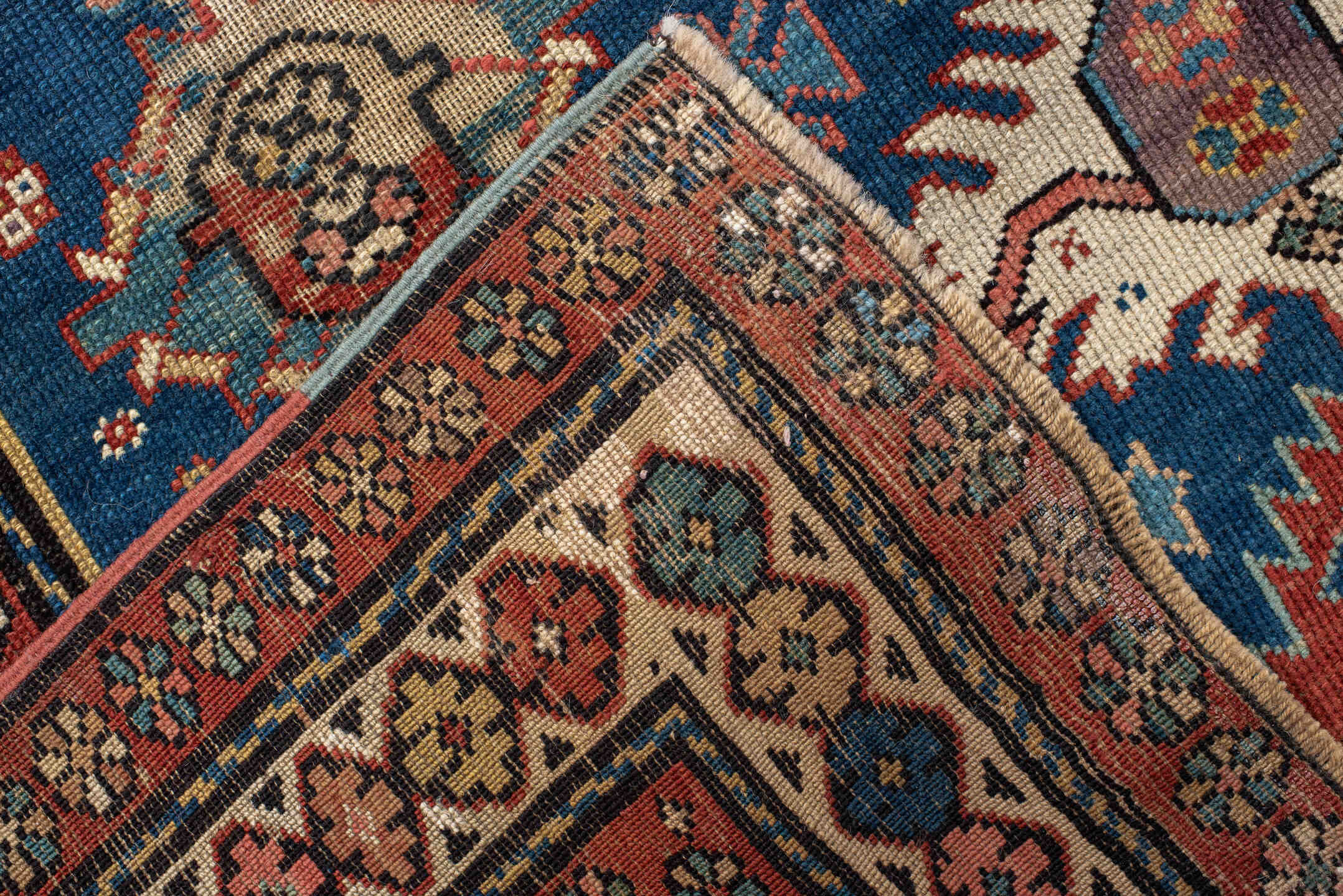 4' x 11' one-of-a-kind handmade vintage Caucasian runner rug. Color palette: arapawa, black, blue, brown, gray