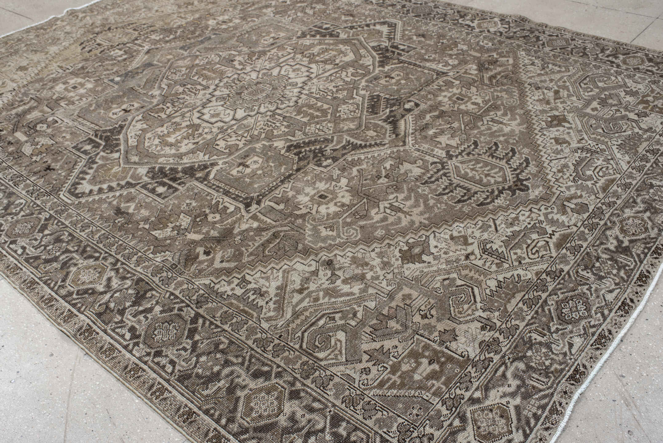 9' x 12' one-of-a-kind handmade antique Heriz large size rug. Color palette: taupe, ivory, brown, camel, charcoal, beige