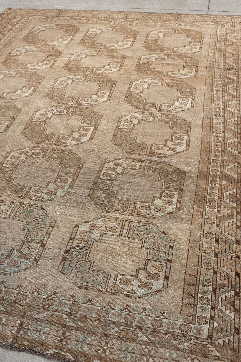 7' x 9' one-of-a-kind handmade antique Afghan rug. Color palette: taupe, camel, beige, ivory, sand, light brown, pale blue