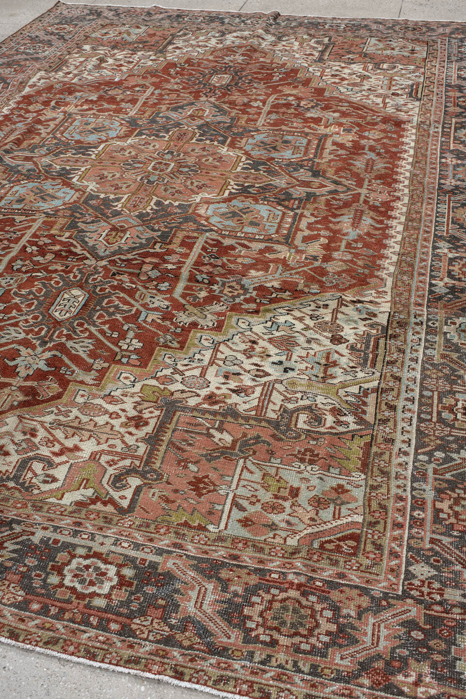 9' x 12' one-of-a-kind handmade antique Heriz large size rug. Color palette: rust, ivory, navy, terra cotta, sage, camel