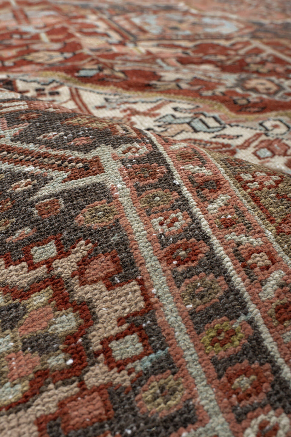 9' x 12' one-of-a-kind handmade antique Heriz large size rug. Color palette: rust, ivory, navy, terra cotta, sage, camel