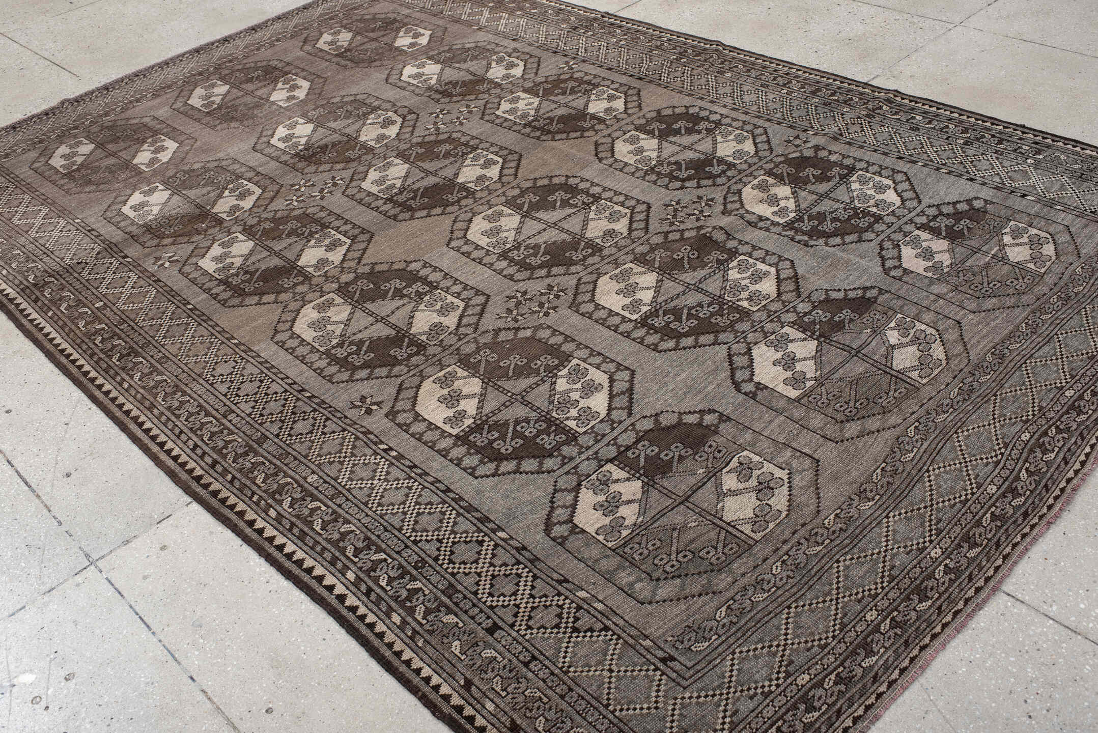 7' x 10' one-of-a-kind handmade vintage Afghan large size rug. Color palette: black, brown, gray, light gray, off-white