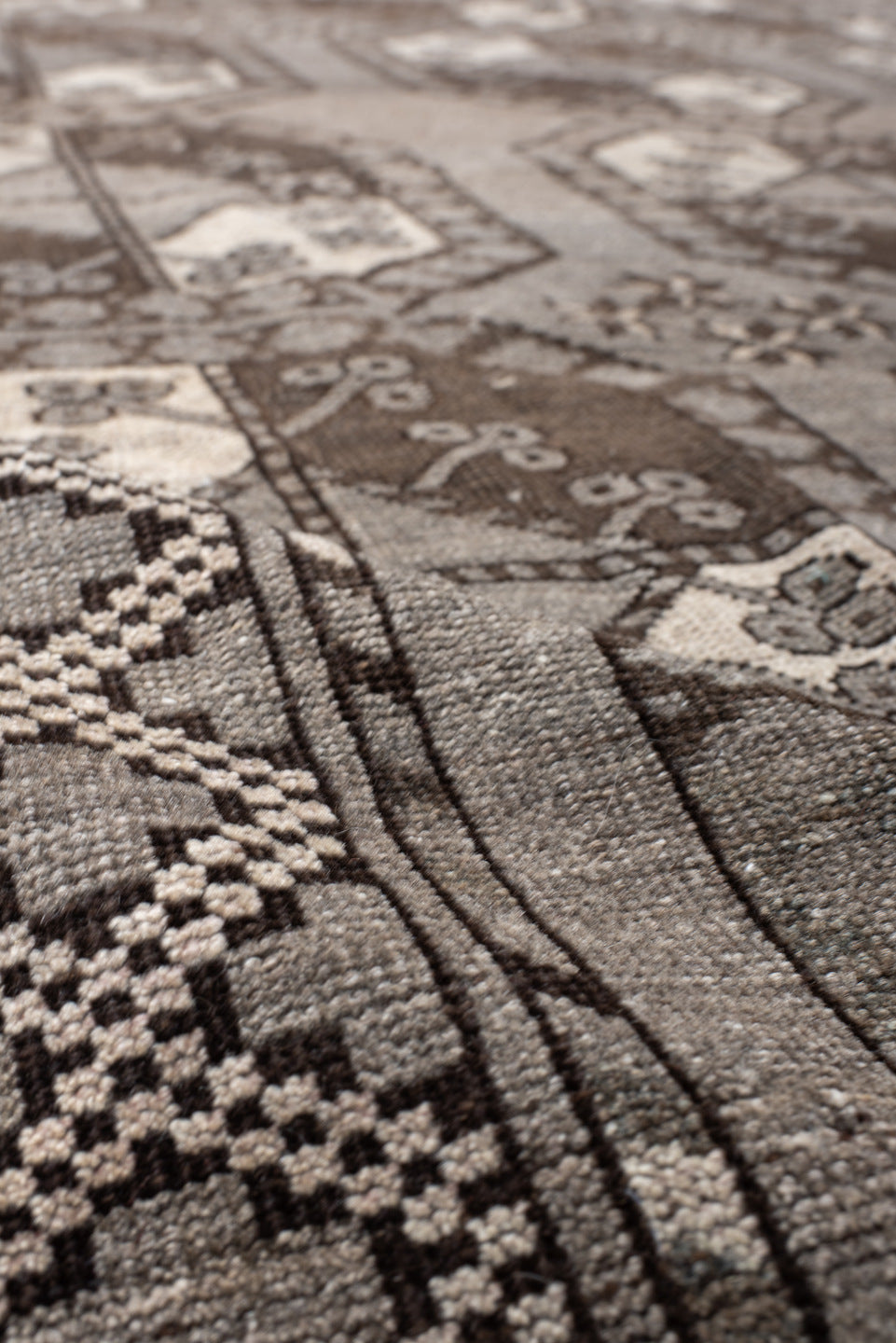 7' x 10' one-of-a-kind handmade vintage Afghan large size rug. Color palette: black, brown, gray, light gray, off-white