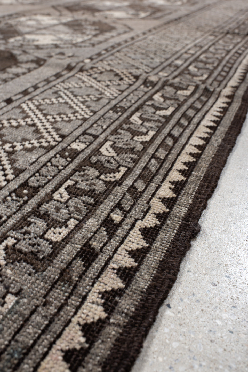 7' x 10' one-of-a-kind handmade vintage Afghan large size rug. Color palette: black, brown, gray, light gray, off-white
