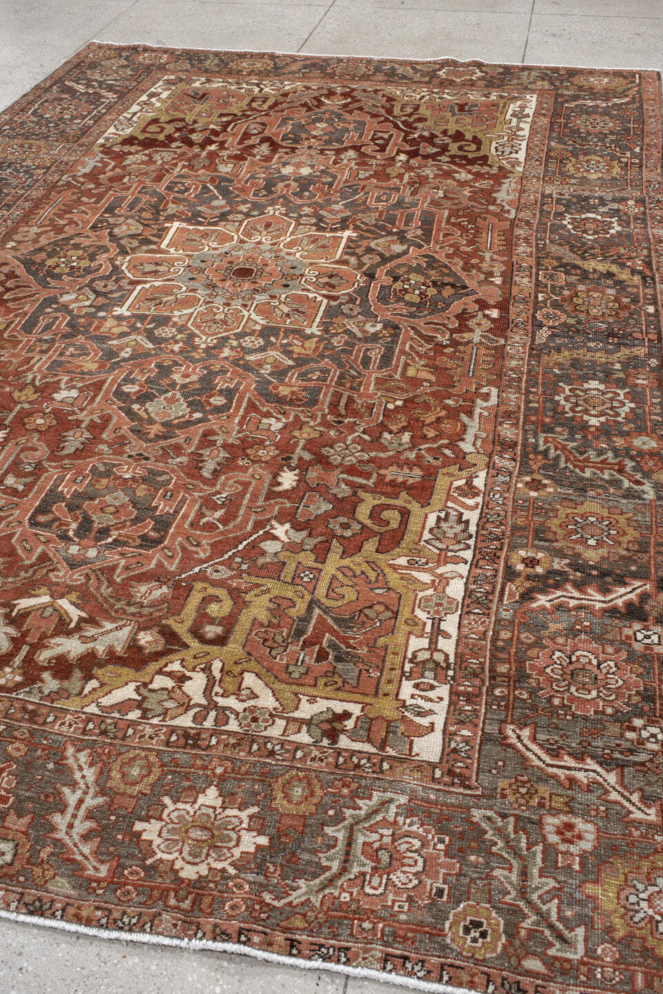 7' x 11' one-of-a-kind handmade antique Heriz large size rug. Color palette: rust, brick, slate, ivory, camel, taupe