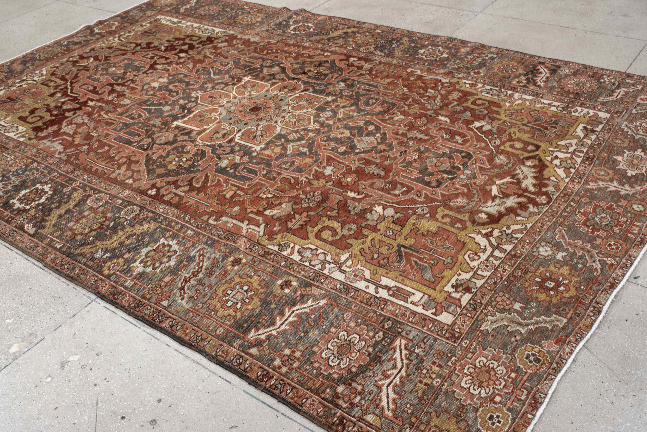 7' x 11' one-of-a-kind handmade antique Heriz large size rug. Color palette: rust, brick, slate, ivory, camel, taupe