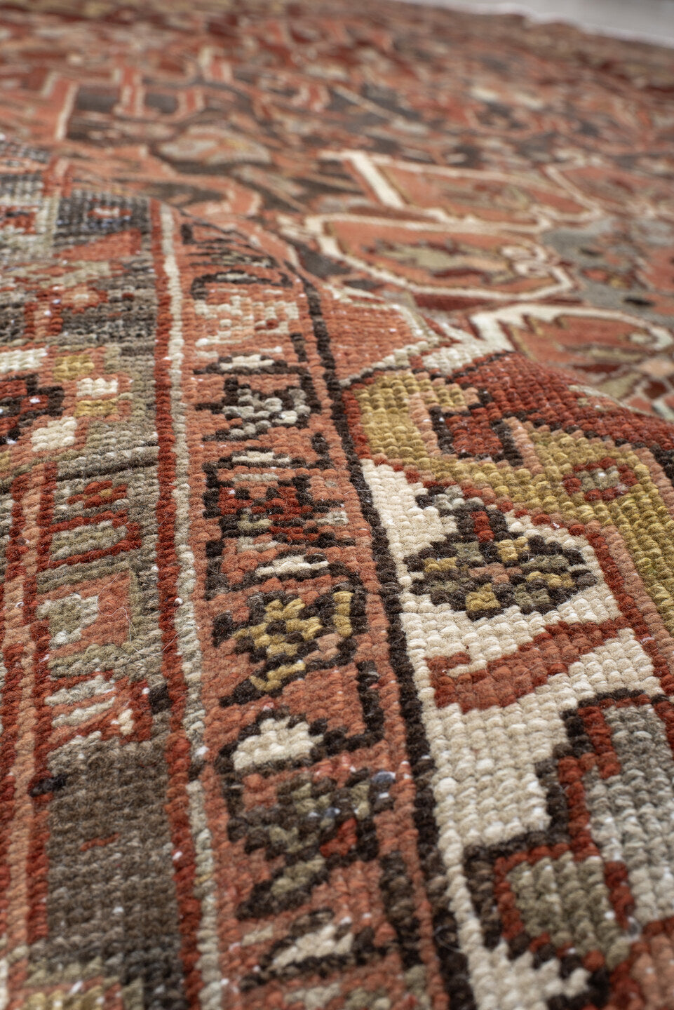 7' x 11' one-of-a-kind handmade antique Heriz large size rug. Color palette: rust, brick, slate, ivory, camel, taupe