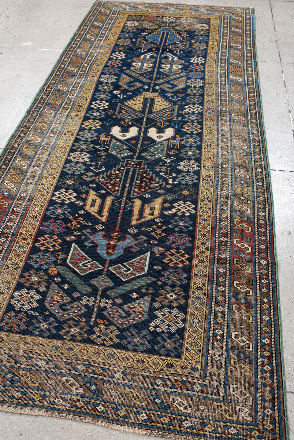 3' x 9' one-of-a-kind handmade vintage Shirvan runner rug. Color palette: navy, camel, ivory, sky blue, taupe, rust, sage