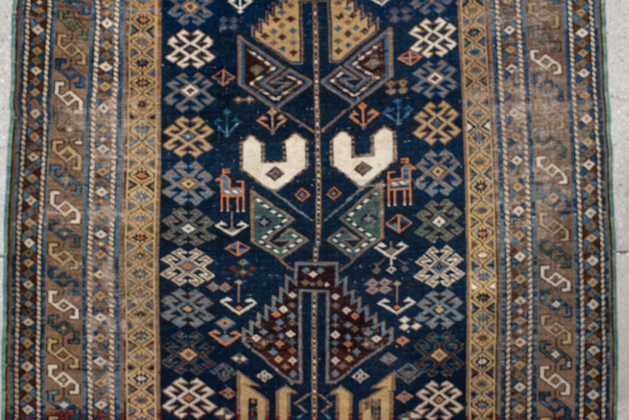 3' x 9' one-of-a-kind handmade vintage Shirvan runner rug. Color palette: navy, camel, ivory, sky blue, taupe, rust, sage