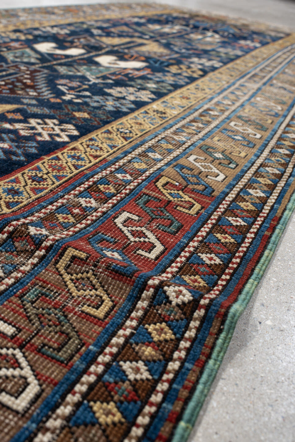 3' x 9' one-of-a-kind handmade vintage Shirvan runner rug. Color palette: navy, camel, ivory, sky blue, taupe, rust, sage