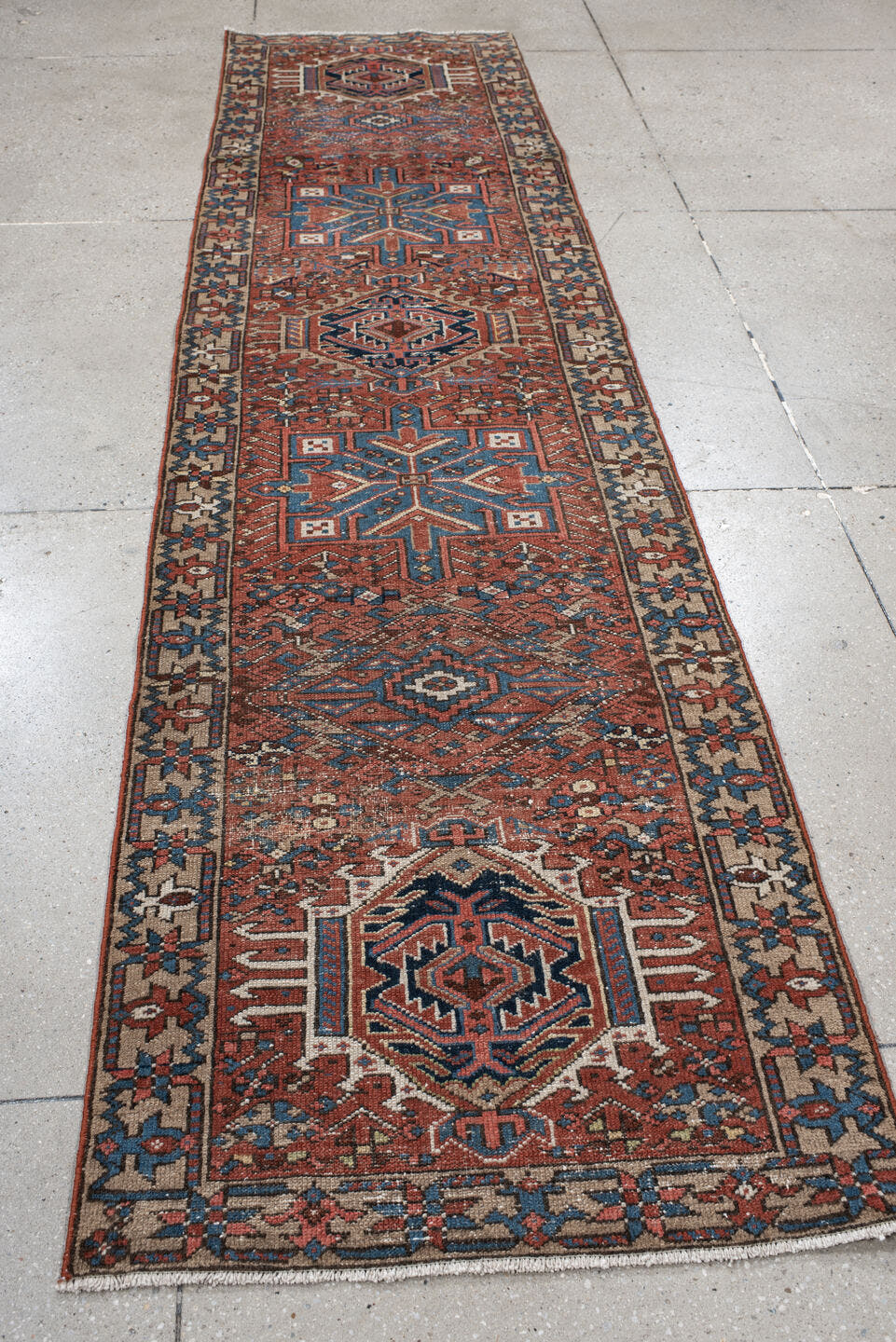 2' x 10' one-of-a-kind handmade vintage Karaje runner rug. Color palette: rust, blue, ivory, navy, taupe, camel, charcoal