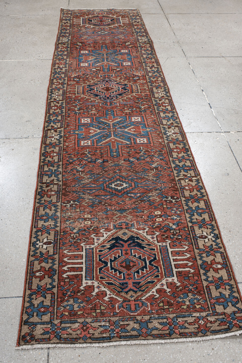 2' x 10' one-of-a-kind handmade vintage Karaje runner rug. Color palette: rust, blue, ivory, navy, taupe, camel, charcoal