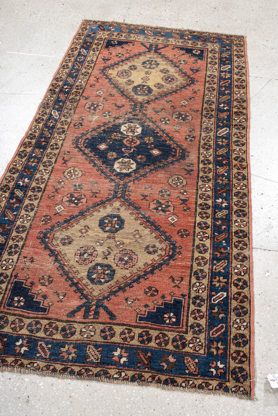 3' x 6' one-of-a-kind handmade antique  runner rug. Color palette: rose, indigo, ivory, rust, navy, camel, crimson, pink
