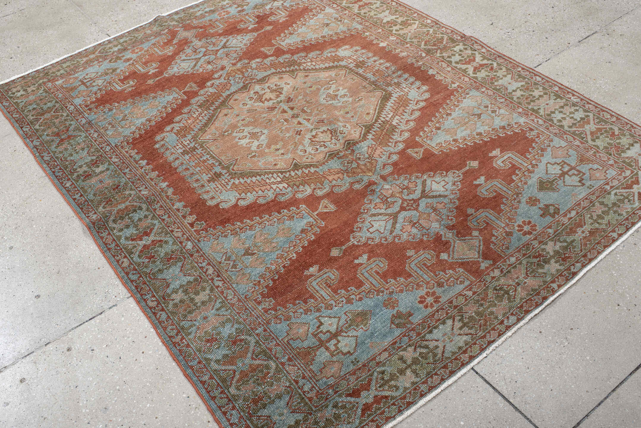 5' x 6' one-of-a-kind handmade vintage Veece rug. Color palette: terra cotta, pale blue, sage, ivory, rose, olive