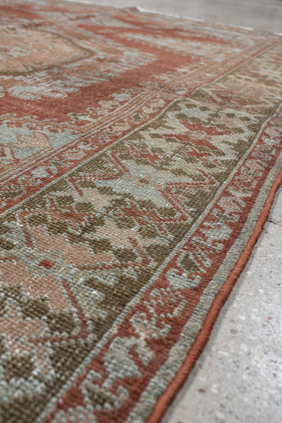 5' x 6' one-of-a-kind handmade vintage Veece rug. Color palette: terra cotta, pale blue, sage, ivory, rose, olive