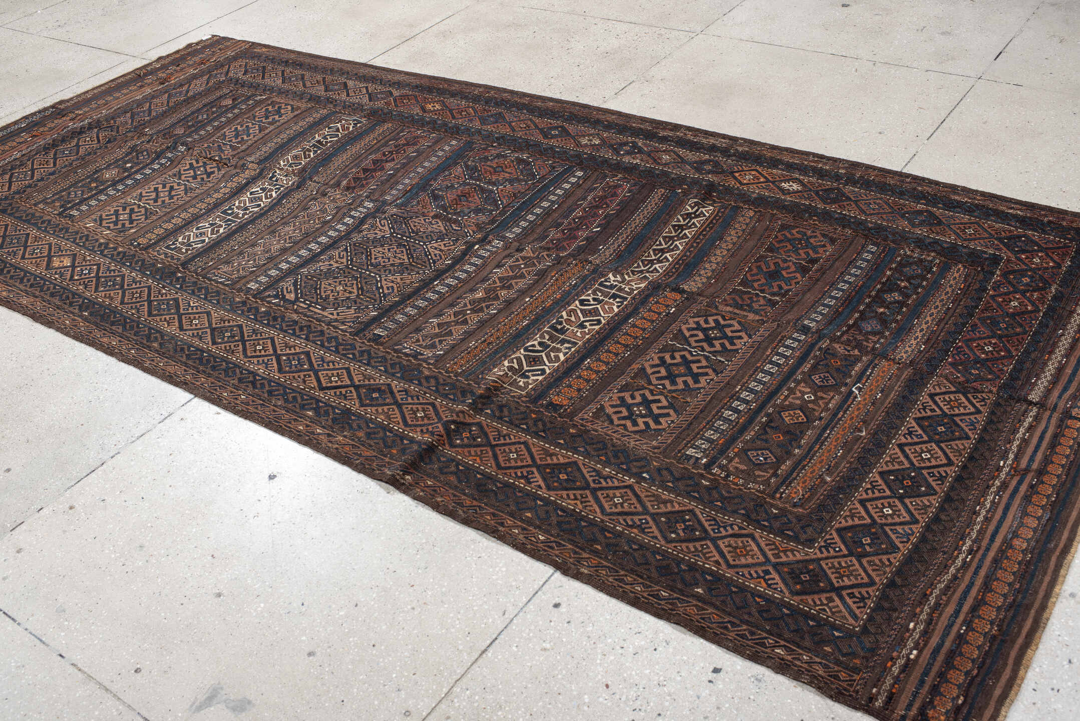 5' x 11' one-of-a-kind handmade vintage Kilim rug. Color palette: brown, indigo, rust, camel, ivory, charcoal, purple