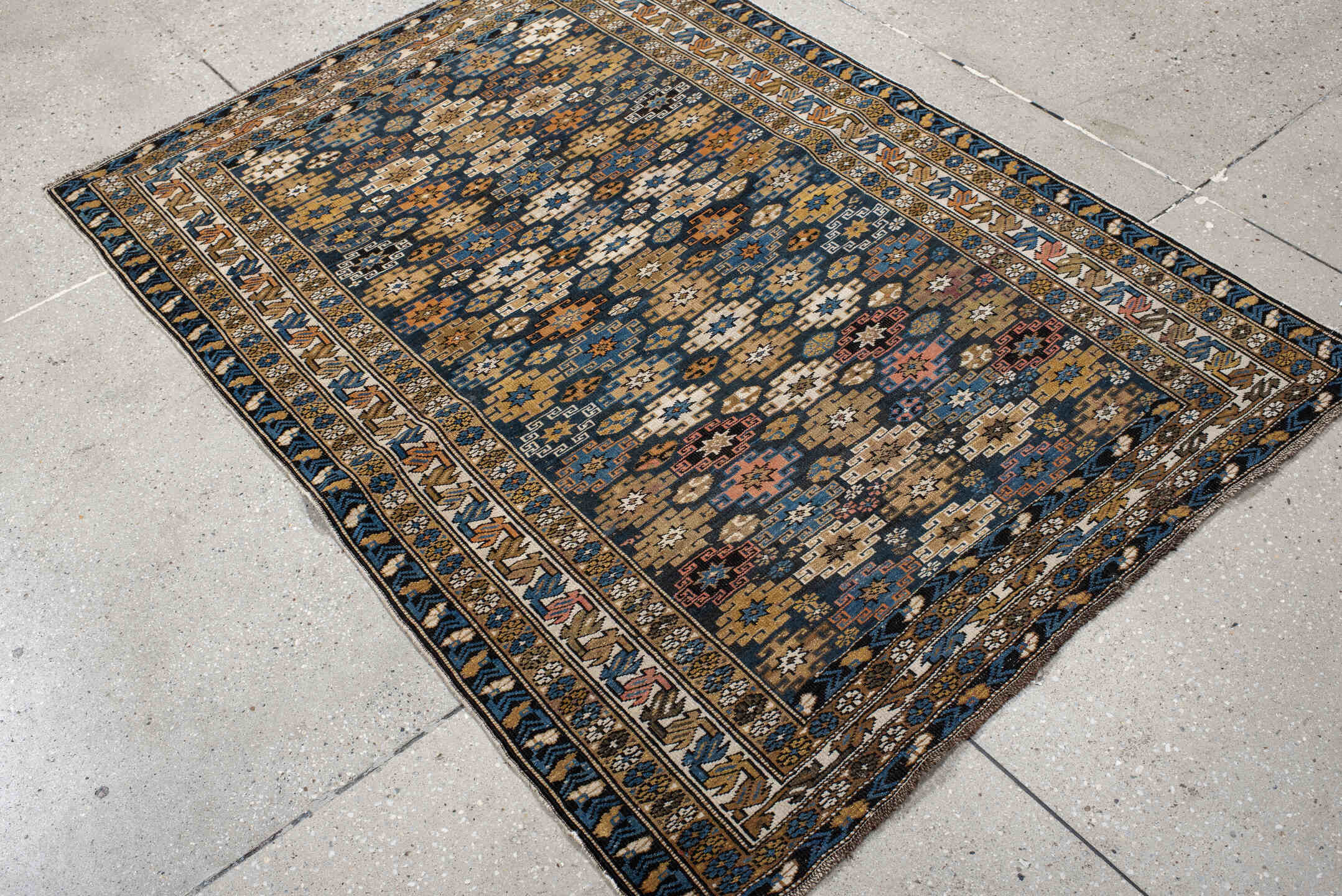 3' x 5' one-of-a-kind handmade vintage Caucasian small size rug. Color palette: navy, camel, ivory, sky blue, rust, brown