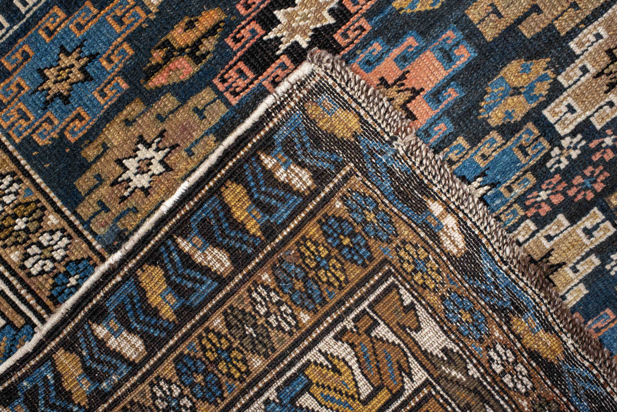 3' x 5' one-of-a-kind handmade vintage Caucasian small size rug. Color palette: navy, camel, ivory, sky blue, rust, brown
