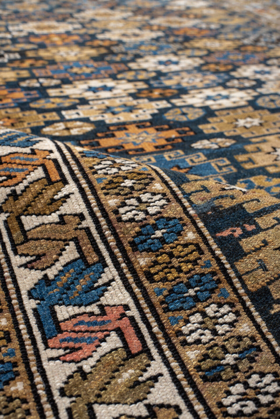 3' x 5' one-of-a-kind handmade vintage Caucasian small size rug. Color palette: navy, camel, ivory, sky blue, rust, brown