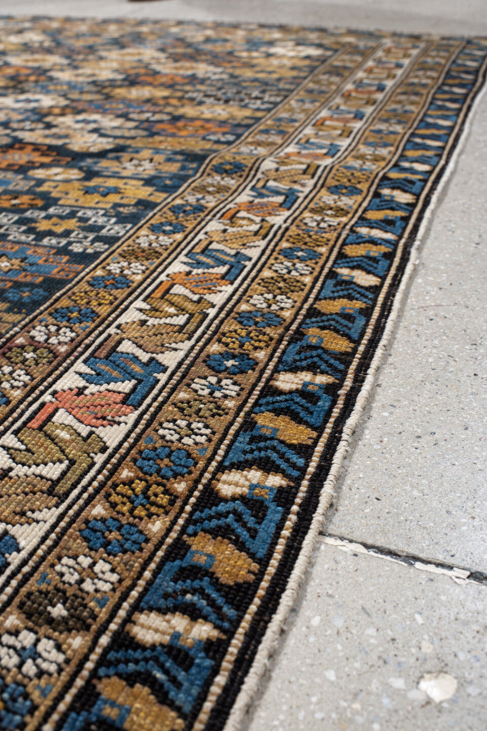 3' x 5' one-of-a-kind handmade vintage Caucasian small size rug. Color palette: navy, camel, ivory, sky blue, rust, brown