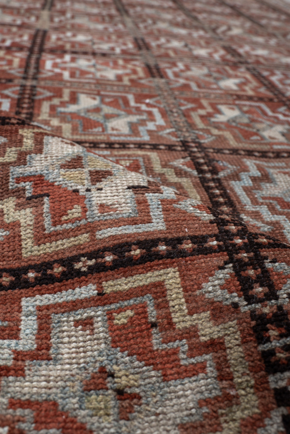 3' x 7' one-of-a-kind handmade vintage Kurd rug. Color palette: rust, ivory, light blue, charcoal, terracotta, camel, brown