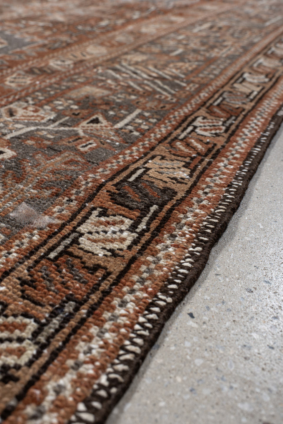7' x 10' one-of-a-kind handmade vintage Karaje large size rug. Color palette: rust, brown, ivory, slate, taupe, camel