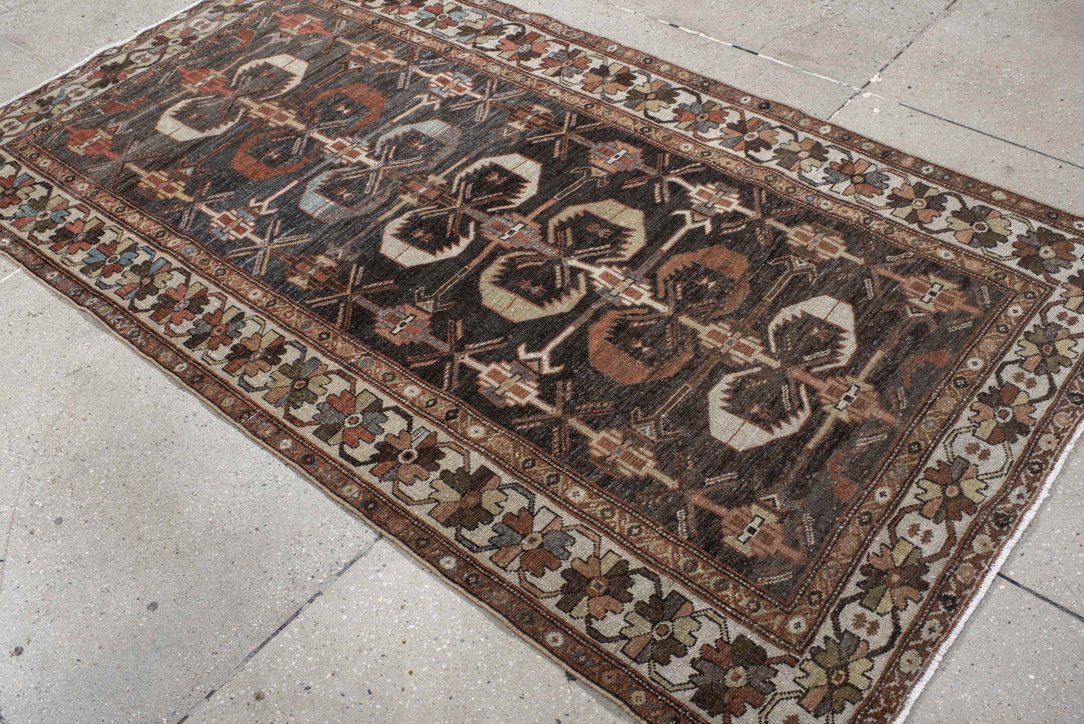 4' x 7' one-of-a-kind handmade antique Shirvan rug. Color palette: charcoal, ivory, rust, taupe, slate, camel, terracotta