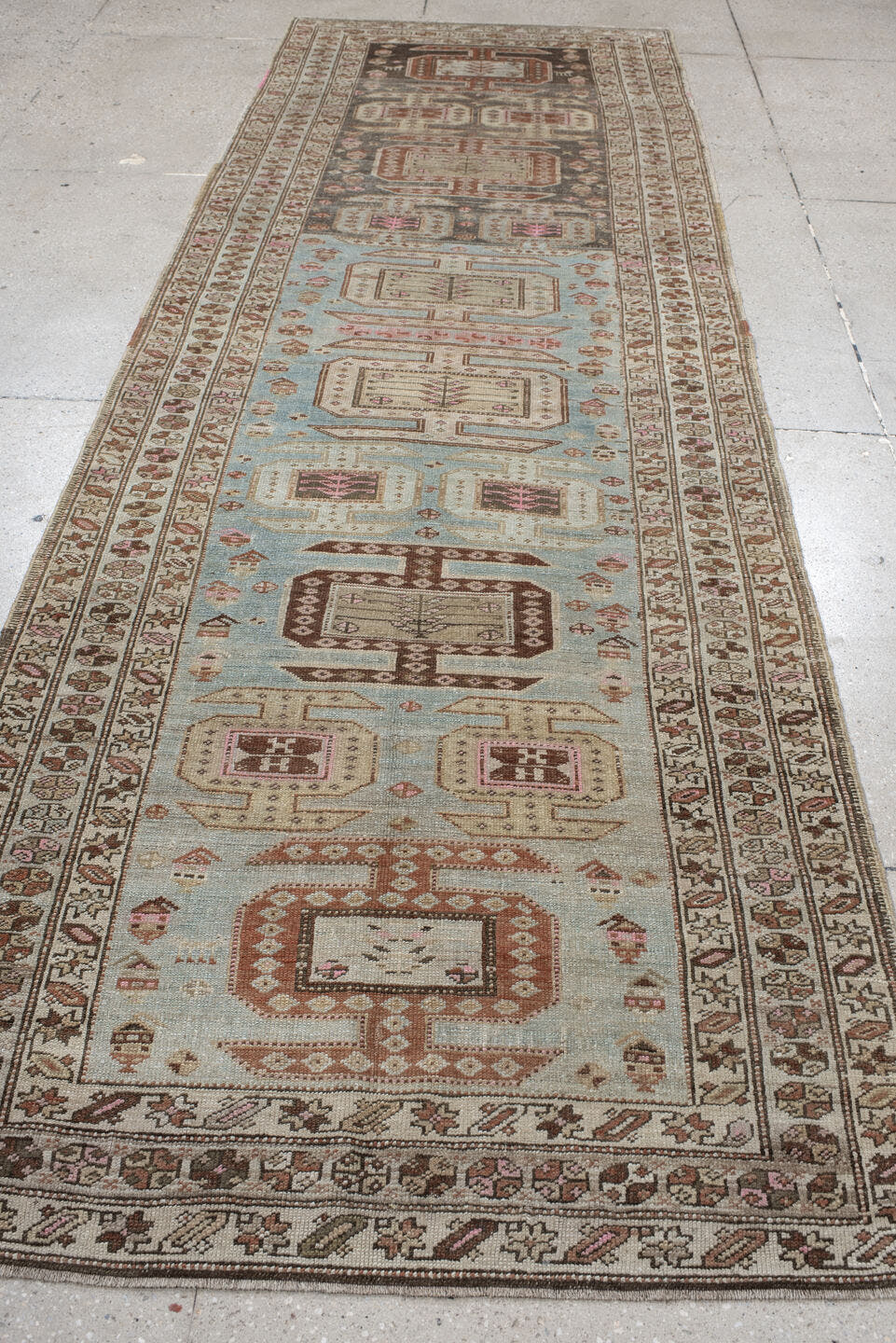 3' x 11' one-of-a-kind handmade vintage runner rug. Color palette: ivory, sky blue, brown, rust, taupe, rose, charcoal