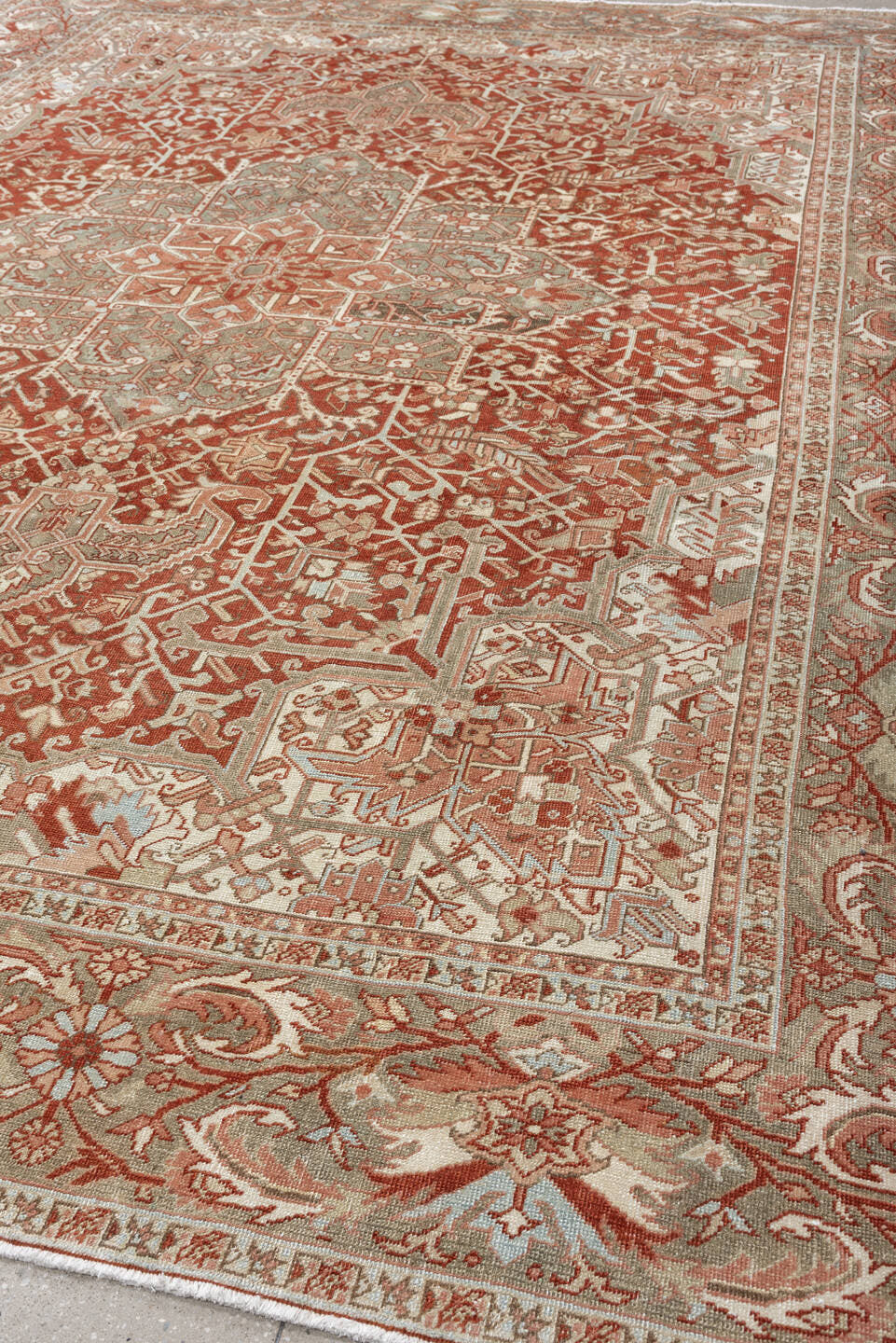 12' x 9' one-of-a-kind handmade vintage Heriz rug. Color palette: terracotta, ivory, pale blue, blue gray, camel, rust