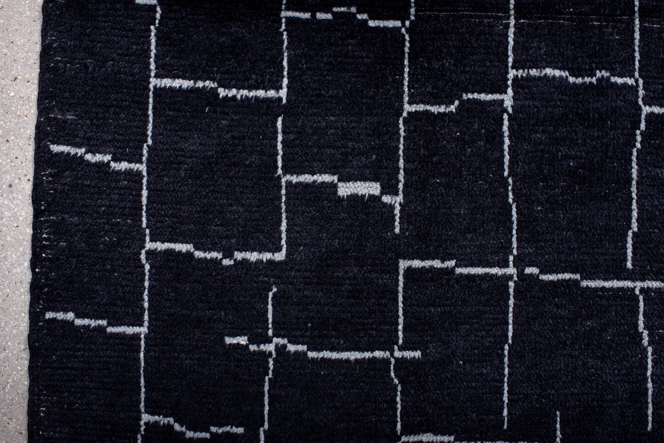 7' x 9' one-of-a-kind handmade vintage Moroccan rug. Color palette: black, ivory