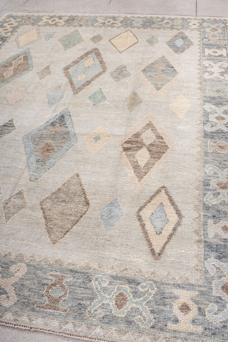 7' x 10' one-of-a-kind handmade vintage Oushak large size rug. Color palette: ivory, pale blue, taupe, cream, sage, camel