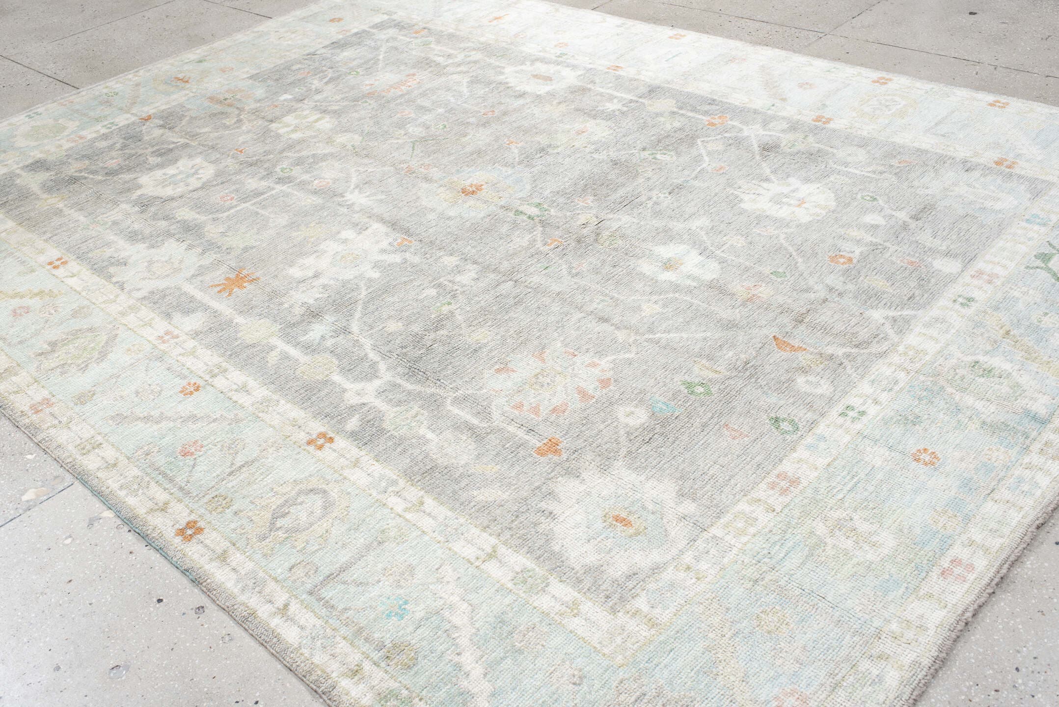 9' x 12' one-of-a-kind handmade vintage Oushak large size rug. Color palette: light gray, ivory, pale blue, sage, soft peach