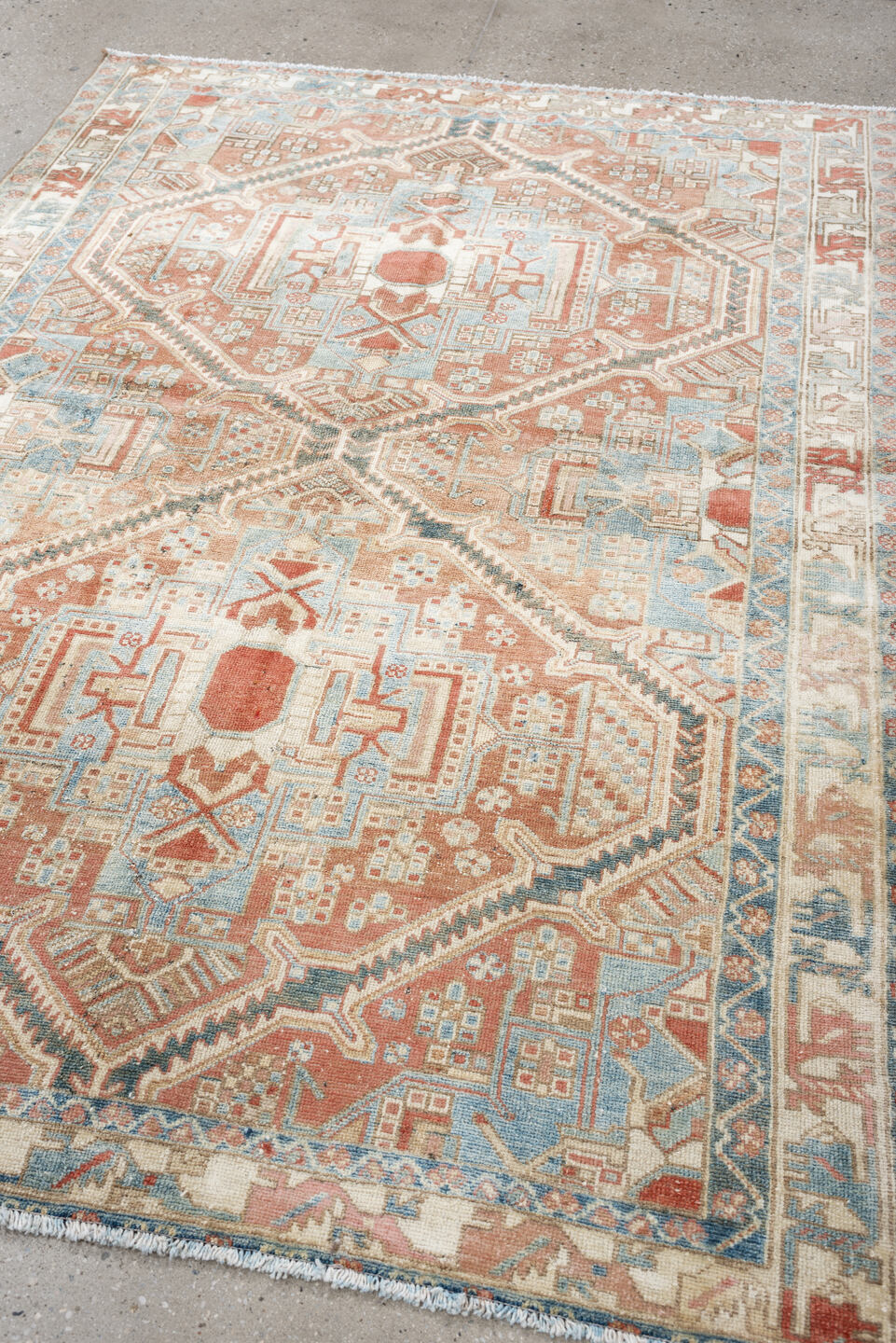4' x 6' one-of-a-kind handmade antique Baktiary rug. Color palette: terra cotta, ivory, sky blue, slate, camel, rust