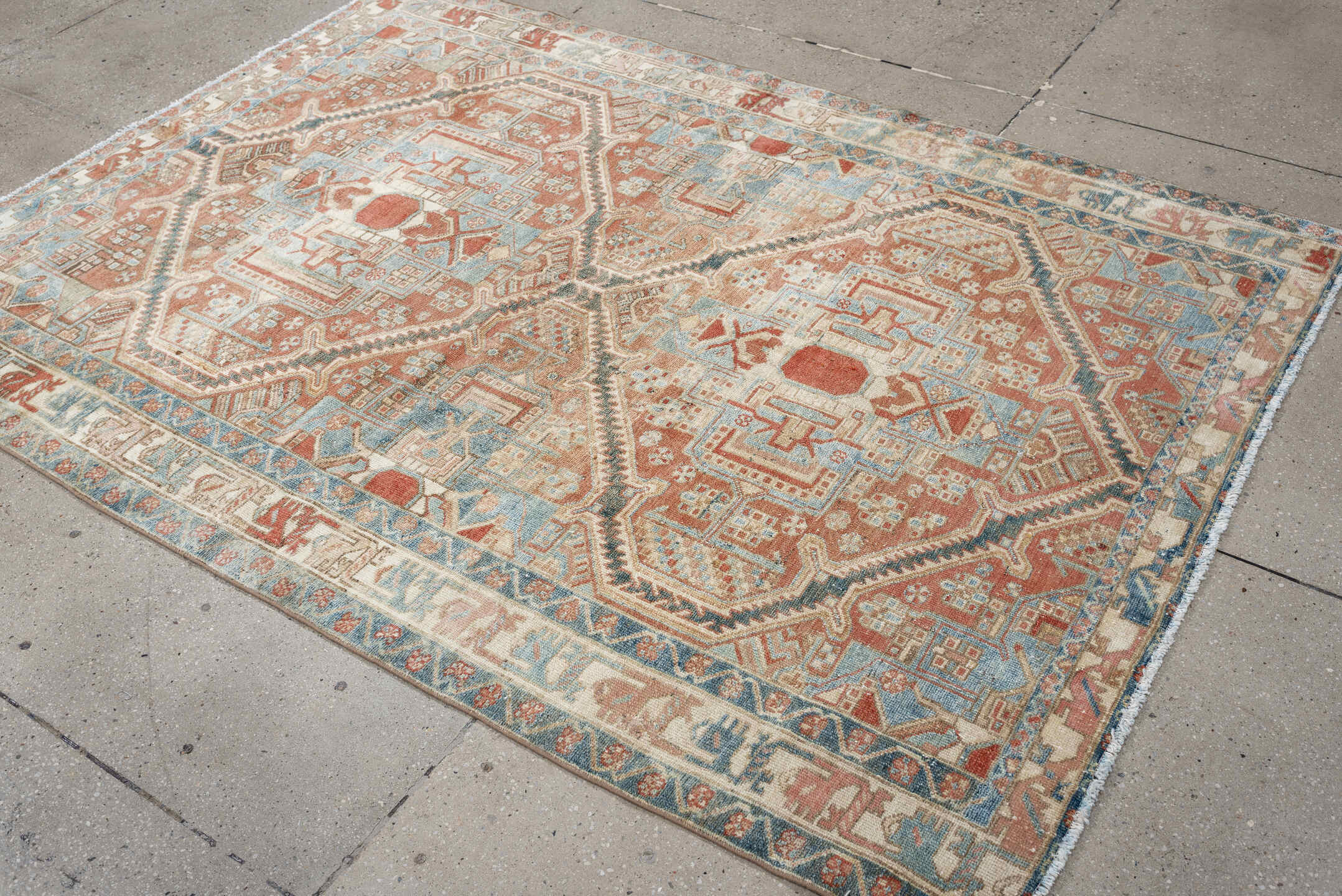 4' x 6' one-of-a-kind handmade antique Baktiary rug. Color palette: terra cotta, ivory, sky blue, slate, camel, rust