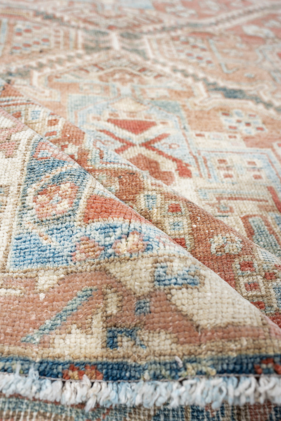 4' x 6' one-of-a-kind handmade antique Baktiary rug. Color palette: terra cotta, ivory, sky blue, slate, camel, rust