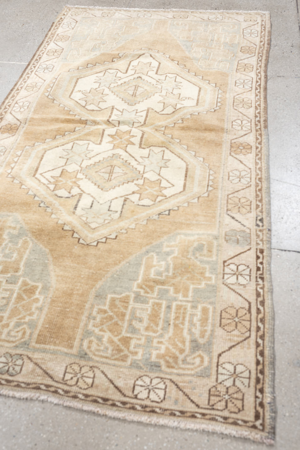 3' x 6' one-of-a-kind handmade vintage Kurd runner rug. Color palette: camel, ivory, pale blue, taupe, sand, light brown