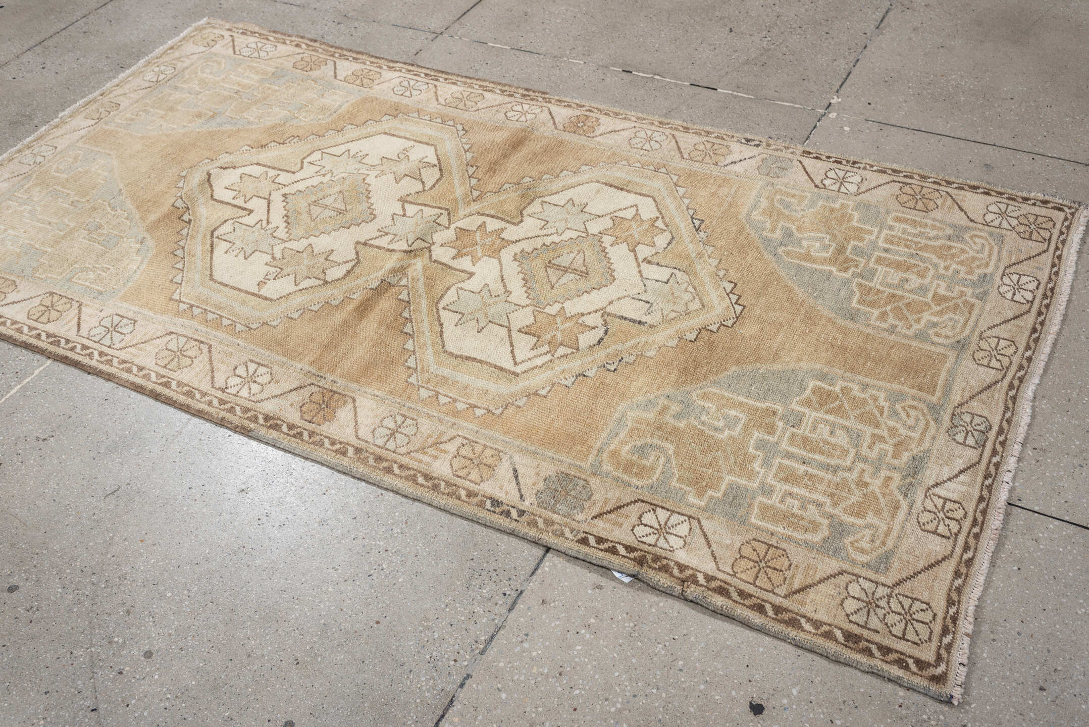 3' x 6' one-of-a-kind handmade vintage Kurd runner rug. Color palette: camel, ivory, pale blue, taupe, sand, light brown